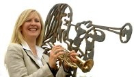 Alison Balsom next to her statue at the junction of Green Street and Melbourn Road in Royston.