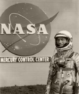 Scott Carpenter poses in full pressure suit in front of Mercury Control Centre's Communications Unit at Cape Canaveral.