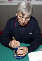 Willie Carson signing a Royal Doulton 'Willie Carson' character jug