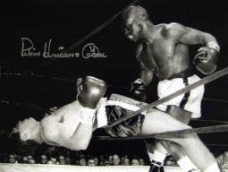 Signed photo of Rubin 'Hurricane' Carter knocking out Florentino Fernandez at the Madison Square Gardens in 1962