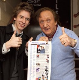 Ciaran Brown gives Ken Dodd a print out of his webpage after 'The Christmas Happiness Show' in Nottingham 2009