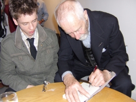 Ciaran Brown watches Alan Sillitoe signing his book