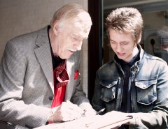 Bruce Forsyth signs a lobby card for Ciaran Brown