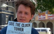 Michael J Fox as Marty McFly with a 'Save the Clock Tower' flyer in 'Back to the Future'
