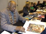 Geoffrey Holder signing Jeff Marshall lithograph