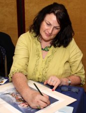 Julie T. Wallace signing the Jeff Marshall litho of 'The Living Daylights'