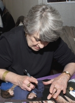 Maggie Kirkpatrick signing a photograph at Memorabilia in 2010