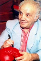 Jake LaMotta signing a boxing glove