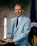 Jim Lovell with model of a Titan rocket 1964