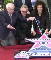 Johnny Grant (Mayor of Hollywood), Roger Taylor & Brian May at the unveiling of the Queen 'Walk of Fame' star on Hollywood Boulevard