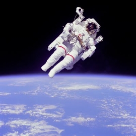 Bruce McCandless uses his hands to control his movement in space while using the nitrogen propelled Manned Manoeuvering Unit (MMU)