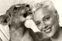 Brigitte Nielsen is kissed by a lion cub