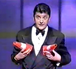 Joe Pasquale on stage with his 'silly cone implants'