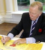 Leslie Phillips signing 'Carry On' poster at Pinewood