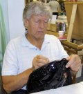 Dave Prowse signing a Darth Vader bag