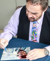 John Rhys-Davies signing a photo of him as Sallah from 'Raiders of the Lost Ark'