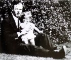 Roger Moore as a baby, with his father in the garden of his home in Stockwell