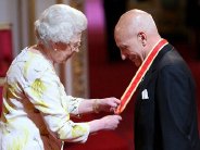 Sir Patrick Stewart receiving his knighthood from the Queen