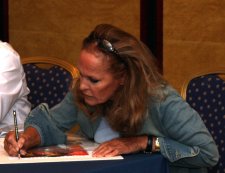 Ursula Andress signing a Jeff Marshall 'Dr No' litho in Birmingham in September 2009