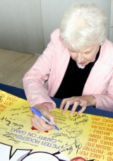 June Whitfield signing 'Carry On' poster