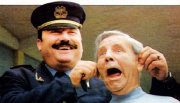 Norman Wisdom is 'arrested' by an Albanian policeman