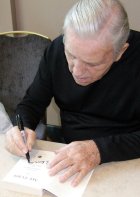 Norman Wisdom signing his autobiography 'My Turn'