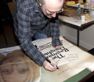 Simon Rouse signing 'The Ragman's Daughter' poster