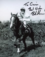 Photo signed by Bob Champion showing Aldaniti jumping the last fence in the 1981 Grand National