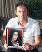 Mark Lester with his signed photograph from Michael Jackson